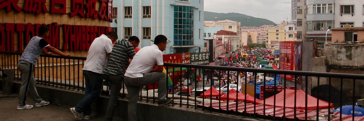 Men on a balcony overlooking the city