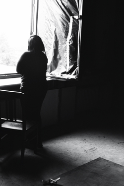 One actress resting from rehearsals in the abandoned postindustrial asylum camp (Jonas Tinius, 2015)