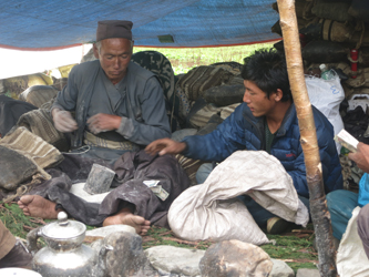 Gori opens his Lukal (saddlebag) from which he tips Tibetan salt into his lap (Anthony Howarth, 2016)