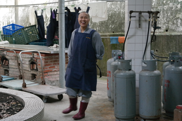 Novice nun laughing after morning duties in the monastery, Chiayi, Taiwan (Nancy Chu, 2016)