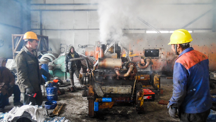 Mongolian mechanics feel relieved after spending three days fixing the engine of an extractor, Mongolia (Ruiyi Zhu, 2017)