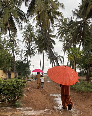 Children walking through the temple’s backyard towards the Indian Ocean