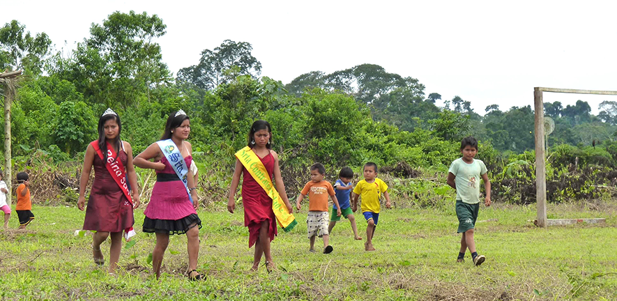 Shuar girls readying for a beauty queen competition which prepares them for the future. They are accompanied by children off to play football, another important index of the future, Natalia Buitron, 2012.