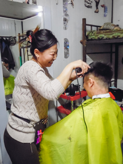 A Mongolian assistant accountant runs a makeshift barbershop in the workers’ dormitory in her spare time, Mongolia (Ruiyi Zhu, 2017)