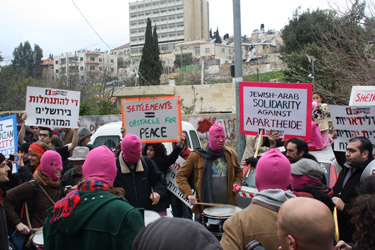 Activists in a drum circle wear pink face masks (Fiona Wright, 2014)